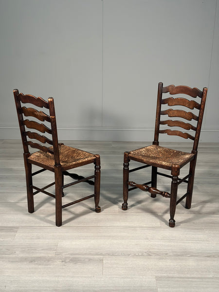 A Pair Of Antique Elm Rush Ladderback Chairs