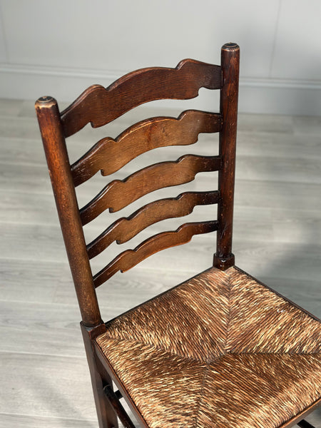 A Pair Of Antique Elm Rush Ladderback Chairs