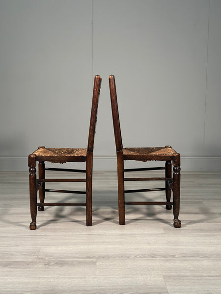 A Pair Of Antique Elm Rush Ladderback Chairs