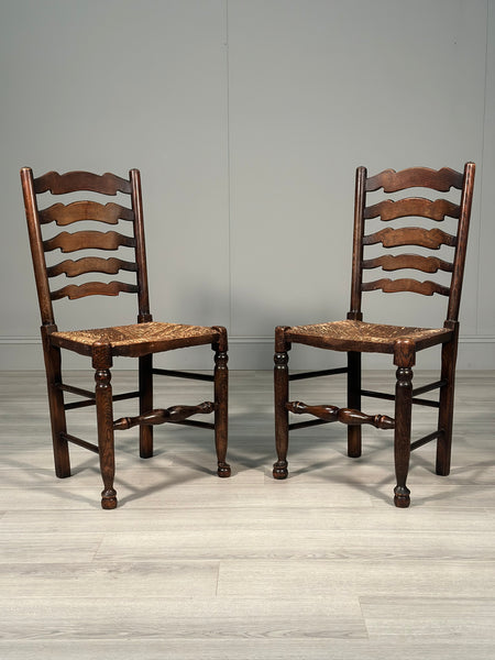 A Pair Of Antique Elm Rush Ladderback Chairs