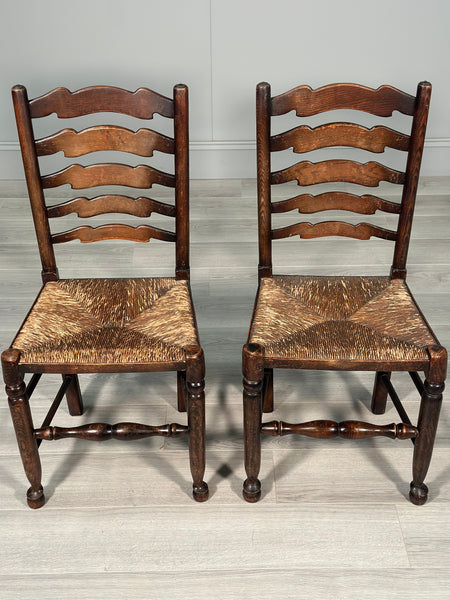 A Pair Of Antique Elm Rush Ladderback Chairs
