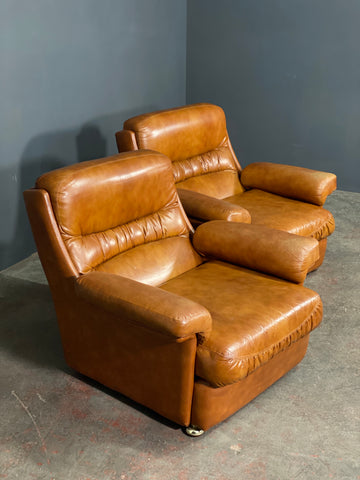 A Vintage Pair Of Rest Assured Leather Arm Chairs