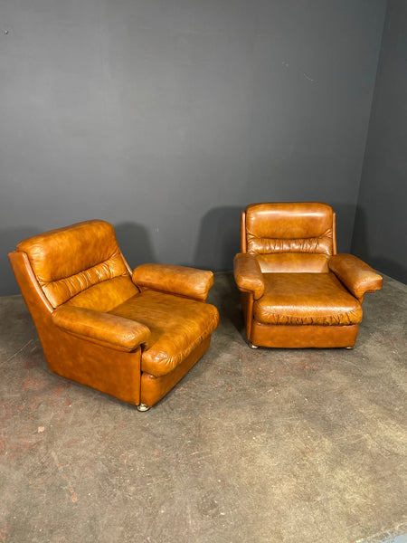 A Vintage Pair Of Rest Assured Leather Arm Chairs