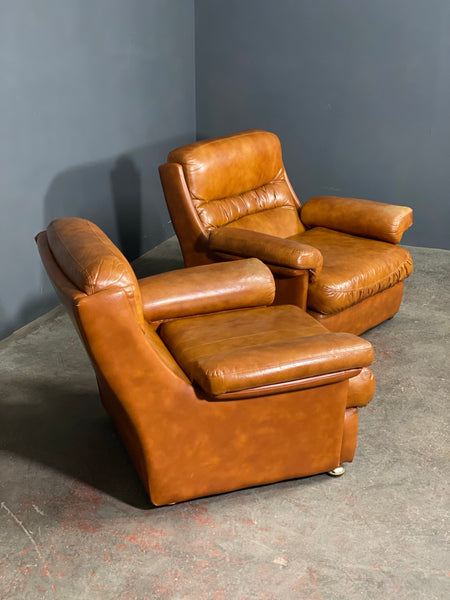 A Vintage Pair Of Rest Assured Leather Arm Chairs